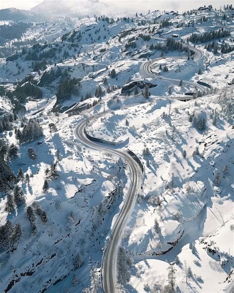 Premium Photo Aerial View Of Winding Road In Mountains With Snow