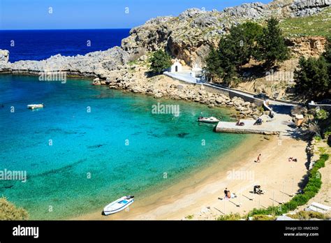 St Pauls Bay and Beach with Lindos Acropolis in the background, rhodes ...