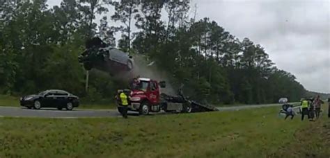 Watch Car Goes Airborne After Driving Up Back Of Tow Truck At Full