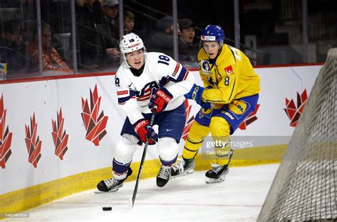 Jimmy Snuggerud for Team USA Skates with the puck behind net with ...