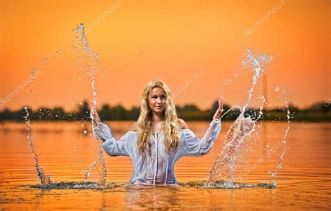 Sexy Blonde Woman In Water At Sunset Beautiful Swimsuit Model In The