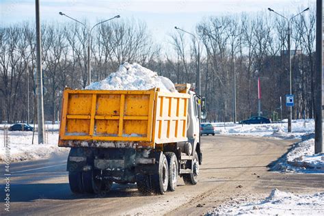 Dump Truck Full Of Snow Driving Through City Street Snow Hauling Dump