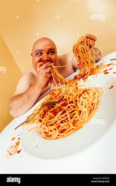 Crazy man eating plate of spaghetti Stock Photo - Alamy