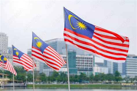 The Malaysia flag is also known as Jalur Gemilang waving with a city in the background ...