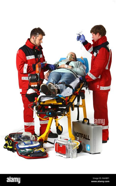 Paramedics with emergency equipment, first aid kit with bandages ...