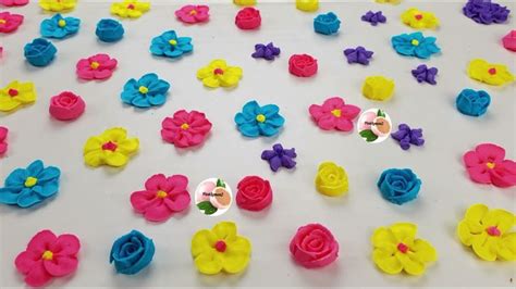 There Are Many Different Colored Flowers On The White Tablecloth With