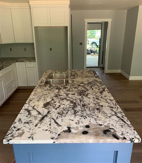 Blue Painted Cabinets With White Splendor Granite