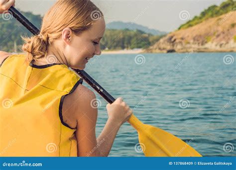 Smiling Young Woman Kayaking On Sea Happy Young Woman Canoeing In Sea