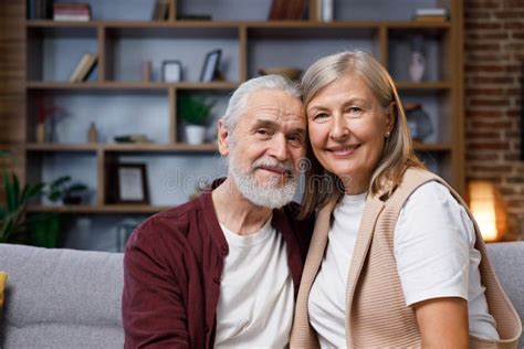 Mature Happy Couple Smiling At The Camera With A Dazzling Smile