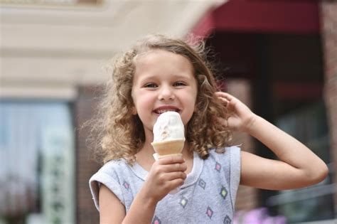 Premium Photo Portrait Of Cute Girl Holding Ice Cream