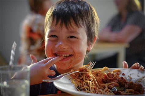 "Young Boy Eating Spaghetti" by Stocksy Contributor "Rowena Naylor ...