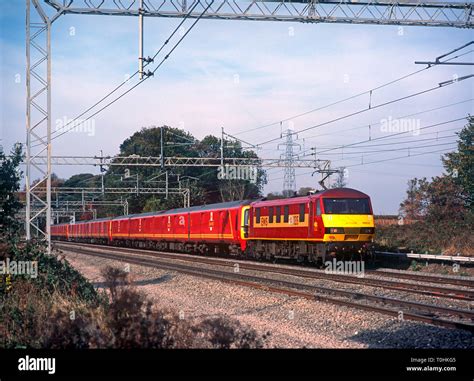 A class 90 electric locomotive number 90035 with three class 325 mail ...