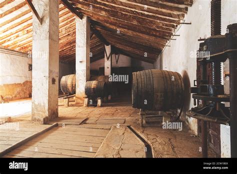 Red Wine Barrels Stacked In The Old Cellar Of The Vinery In Spain