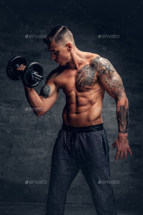 Athletic Male With Tattoo On His Chest Doing Biceps Workouts Wi Stock