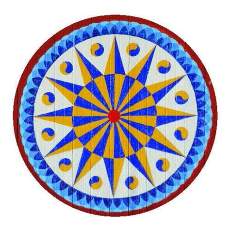 A Circular Object With Blue Yellow And Red Designs On The Center Is