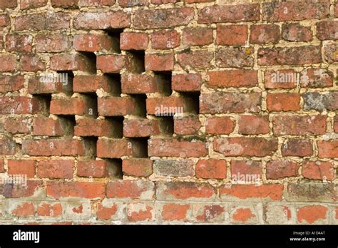 Old Rustic Brick Wall With Holes Left In Diamond Pattern To Allow