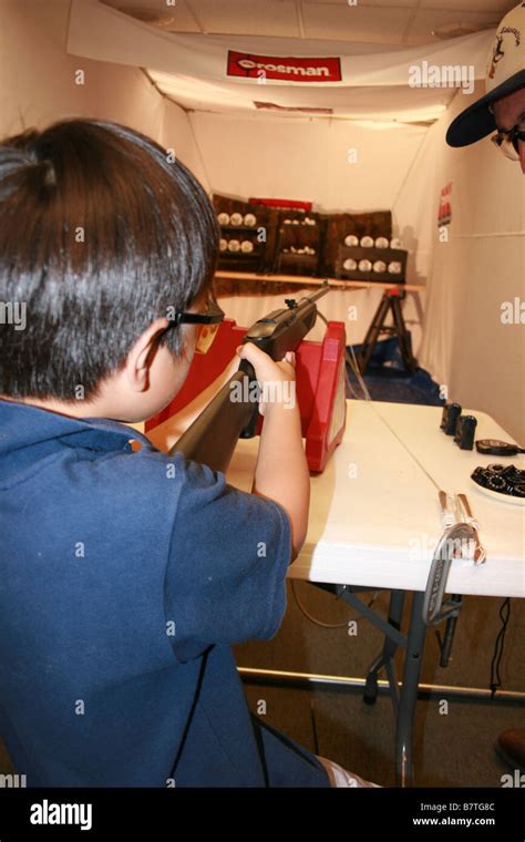 Child Aiming Gun In Shooting Range Stock Photo Alamy