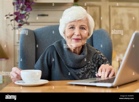 Smiling Senior Woman Using Laptop Stock Photo Alamy