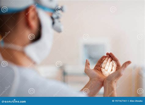 Doctor Neurosurgeon In A Medical Mask In Professional Magnifying