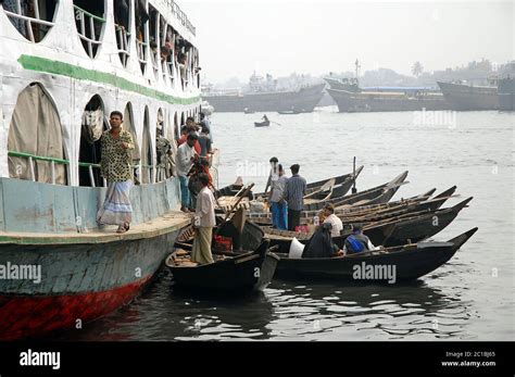 Sadarghat in Dhaka, Bangladesh. Small boats moored alongside a ship on ...