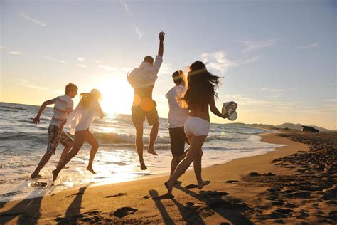 People Group Running On The Beach Stock Photo At Vecteezy