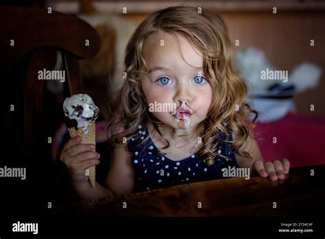 Beautiful little girl eating ice cream with a messy face Stock Photo ...