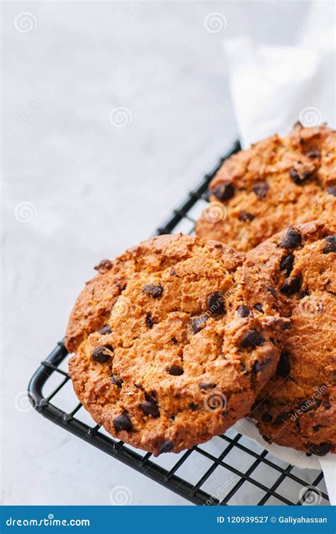 Homemade Chocolate Chips Cookies On A Wire Rack On A White Stone Stock