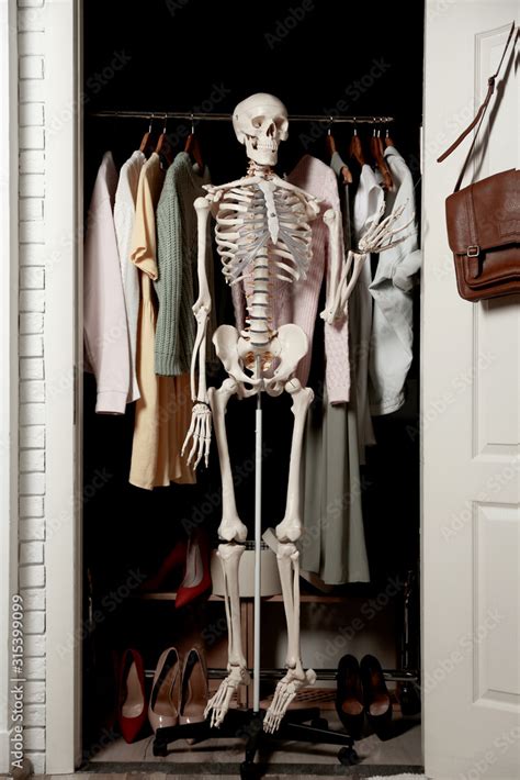 Artificial Human Skeleton Model Among Clothes In Wardrobe Room Stock