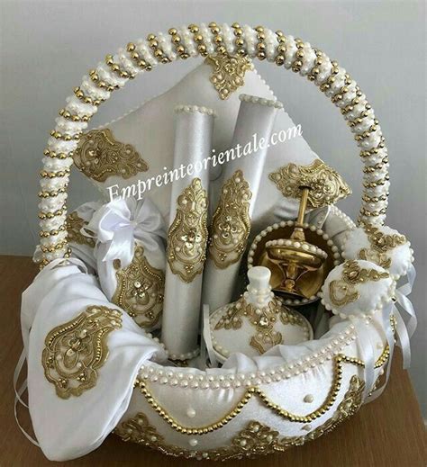 A Basket Filled With White And Gold Items