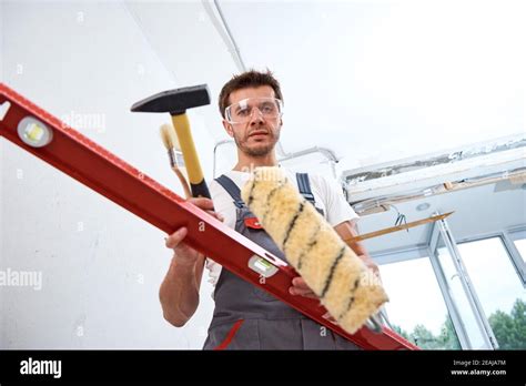 Builder man with a construction tools. Repair concept Stock Photo - Alamy