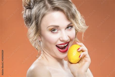 Sexy Fruit Series Closeup Portrait Of Sensual Sexy Caucasian Blond Girl Biting Yellow Lemon