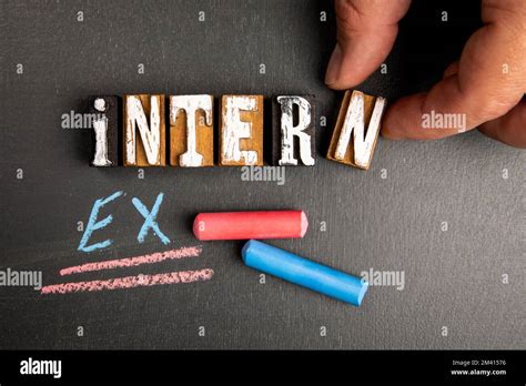 intern  extern concept wooden letter blocks  blackboard