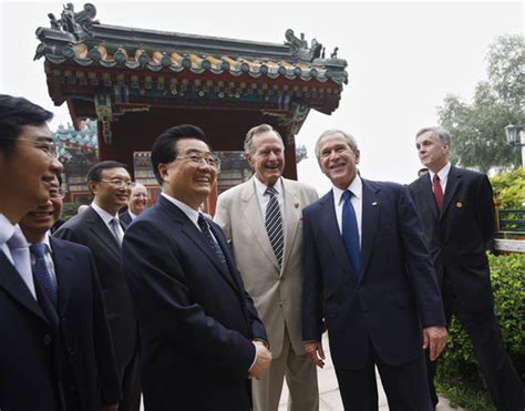 President George W. Bush is joined by his father, former President George H. W. Bush, during ...