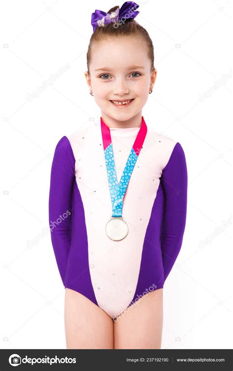 Little Girl Gymnast With A Medal In A Sports Swimsuit Doing Exercises