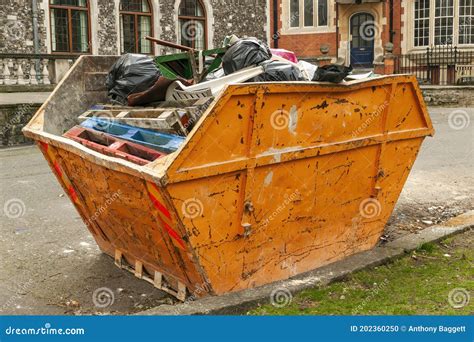 Skip Container Full Of Scrap Waste Household Rubbish Stock Photo