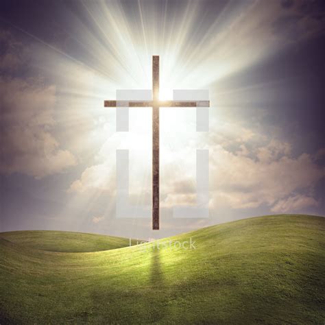 A large glowing cross over a grassy field with... — Photo — Lightstock