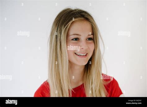 Blonde Teenage Girl Smiling Looking Away From Camera Stock Photo Alamy