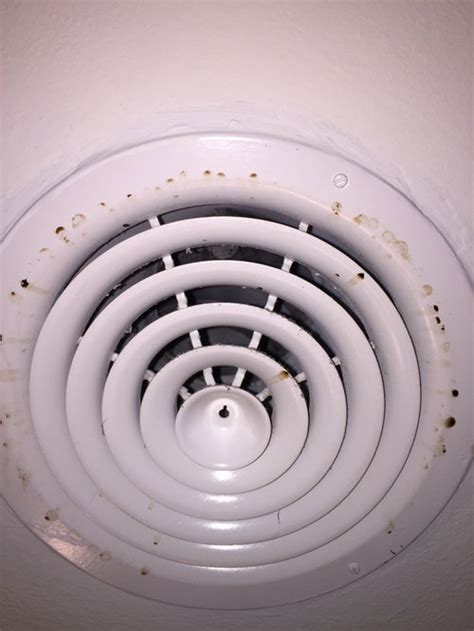 Brown Black Drip Stains On Circular Ac Vents