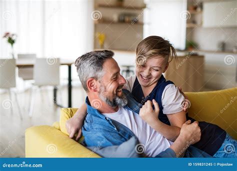 Mature Father With Small Son Sitting On Sofa Indoors Having Fun Stock Image Image Of