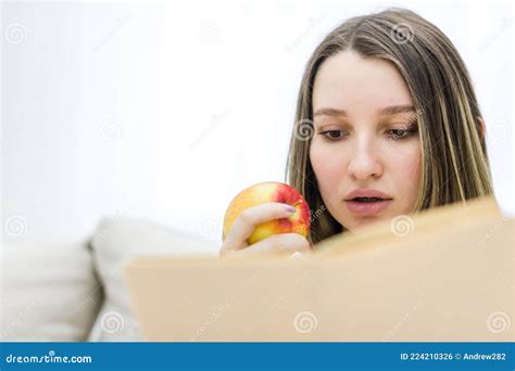 Foto De Una Mujer Embarazada Leyendo Un Libro Y Comiendo Una Manzana