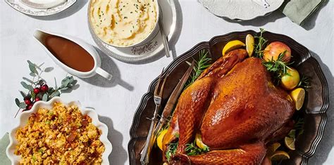 a turkey is sitting on a platter next to other thanksgiving foods