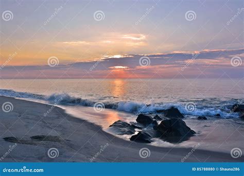 Summer Sunrise At The Shore Over Rock Jetty Stock Photo Image Of Blue