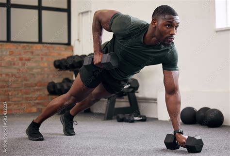 Black man, dumbbell row and training in gym, workout and strong fitness ...