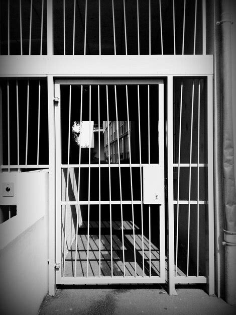 Premium Photo | Close-up of metallic gate in prison