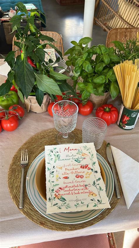 A Place Setting With Tomatoes Basil And Spaghetti On The Table For An