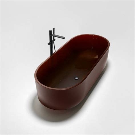 An Oval Shaped Bathtub Is Shown On A White Surface With A Black Faucet