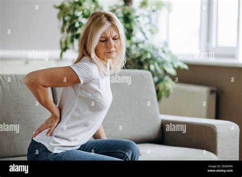 Upset Mature Woman Suffering From Backache Unhappy Senior Blonde