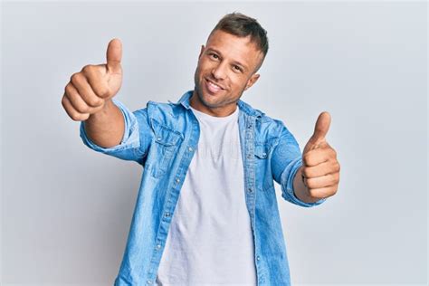 Handsome Muscle Man Wearing Casual Denim Jacket Approving Doing