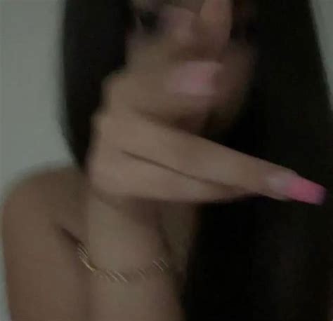 A Blurry Photo Of A Woman Brushing Her Long Hair With A Pink Toothbrush