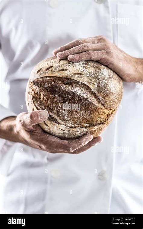 Holding A Loaf Of Bread In His Hands Hi Res Stock Photography And